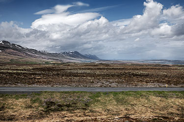 Icelandic landscape of mountains and valley with blue sky and clouds. 